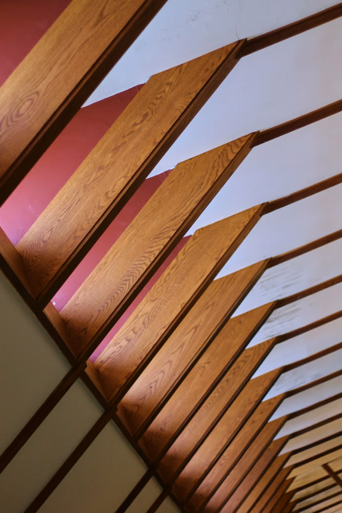 Exposed timber beams running across a ceiling with the roof structure directly above and no attic void